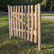 A charming wooden garden gate nestled among vines.